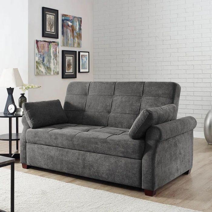 The queen-sized gray couch