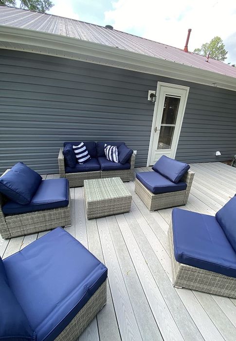 Another reviewer's photo displaying a blue modular sectional, separated into its individual pieces, arranged on a spacious deck.