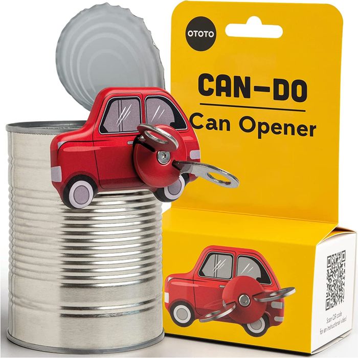 A can opener placed next to its packaging