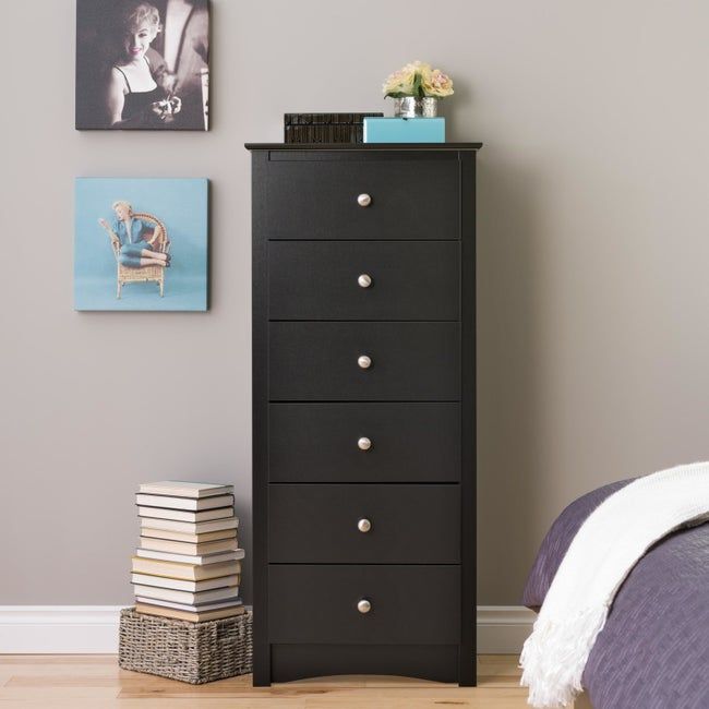 Sleek black six-drawer dresser elegantly placed in a modern bedroom
