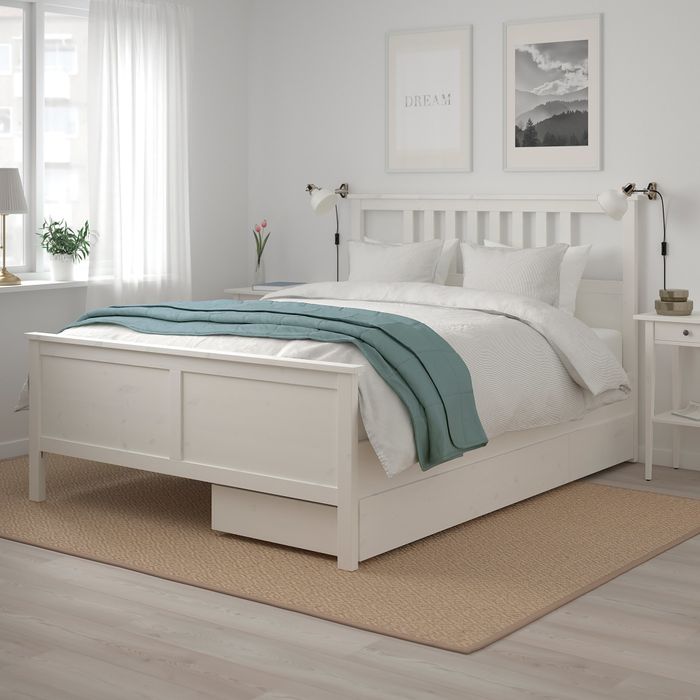 A white bed frame with two practical storage drawers underneath.