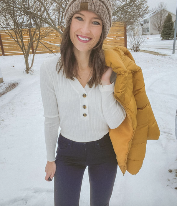reviewer wearing a simple white tee