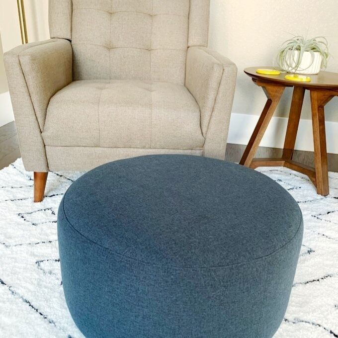 A reviewer’s elegant blue ottoman, seamlessly blending into their cozy home decor.