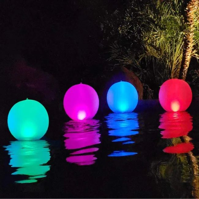 Four brightly colored balls floating cheerfully in the pool.