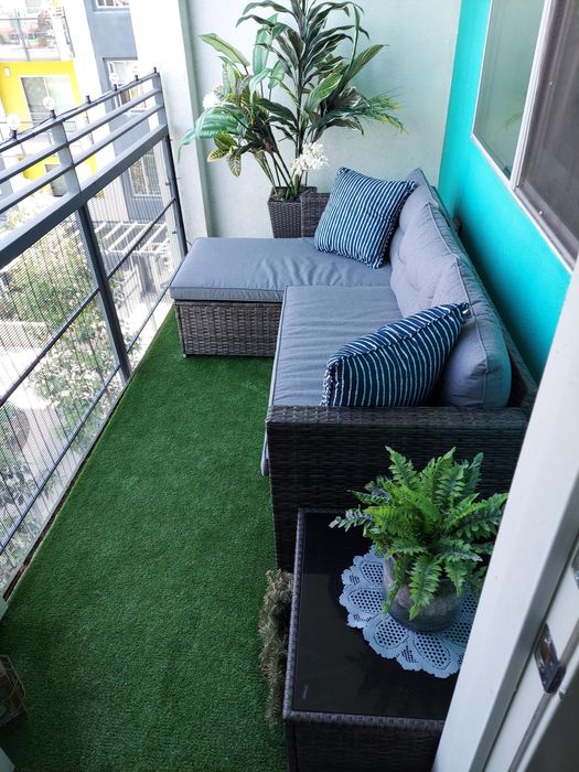 A side view of another reviewer's gray three-piece sectional elegantly placed on a balcony.