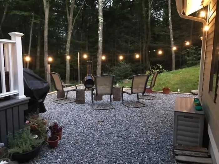 A cozy backyard patio adorned with beautiful string lights creating a warm atmosphere.