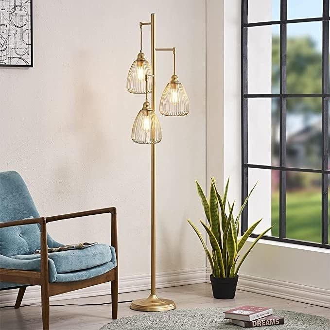 the floor lamp placed in a living room, positioned next to a window, chair, and a plant