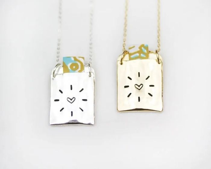 Silver and gold love note necklaces.
