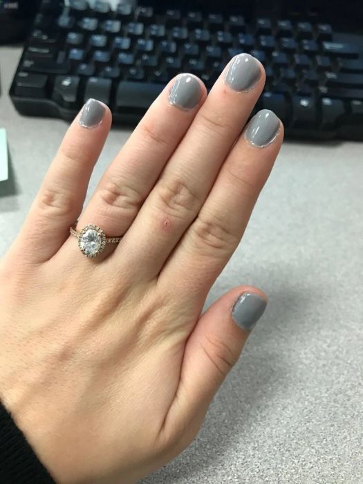 A close-up of a hand with beautifully manicured nails.