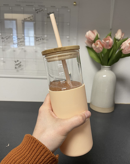 reviewer holding a pink-colored tumbler