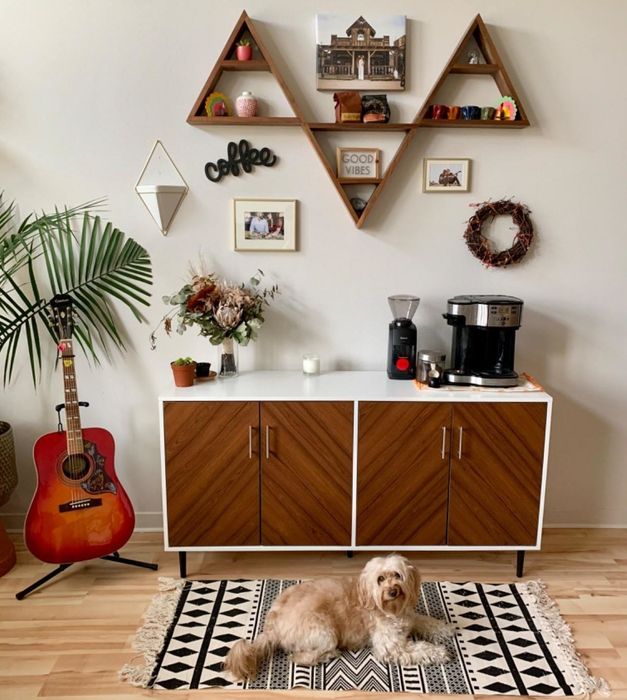 a reviewer photo of the white cabinet with a dog in front of it