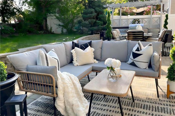 Gray L-shaped outdoor sectional paired with a rectangular coffee table