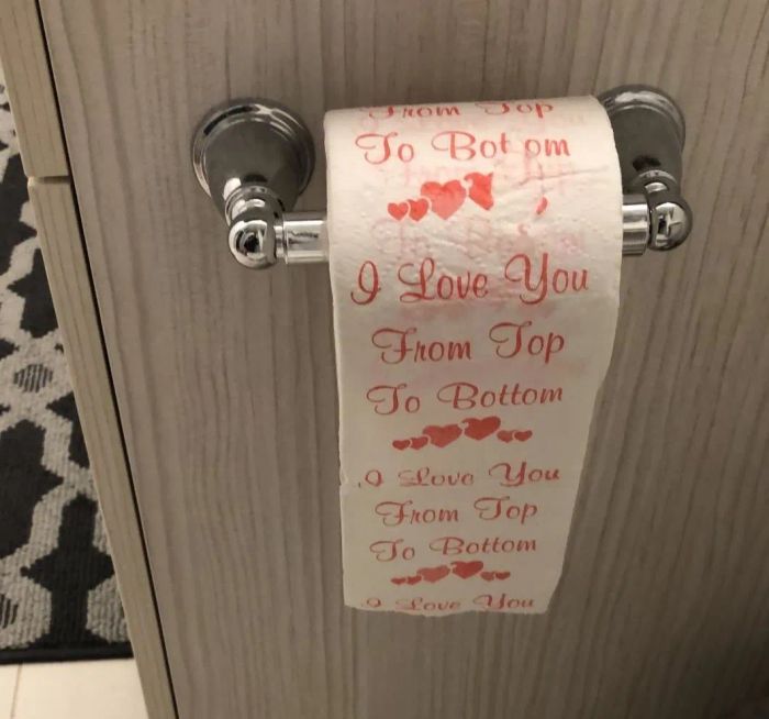 A reviewer's image showcasing the toilet paper, which reads, 'I love you from top to bottom.'
