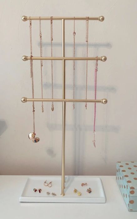 A reviewer’s photo showcasing the elegant white and brass jewelry stand.