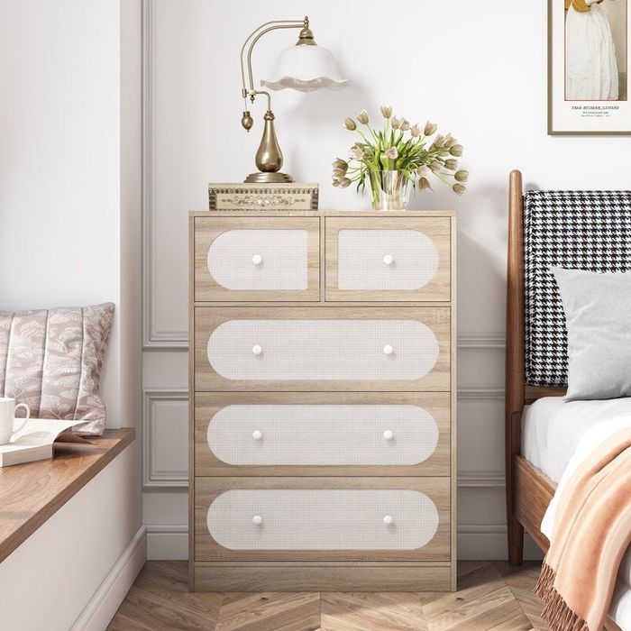 Five-drawer light wood dresser with rattan accents