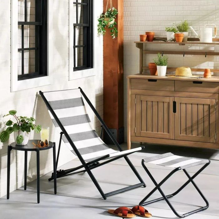 A chair with a matching ottoman (sold separately) placed on a deck for outdoor relaxation.