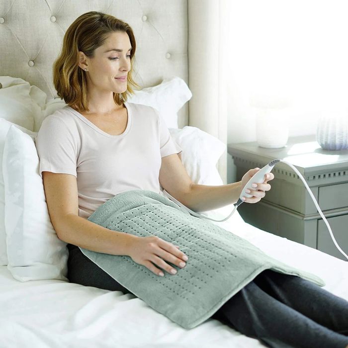 A model using the heating pad over her lap for comfort.