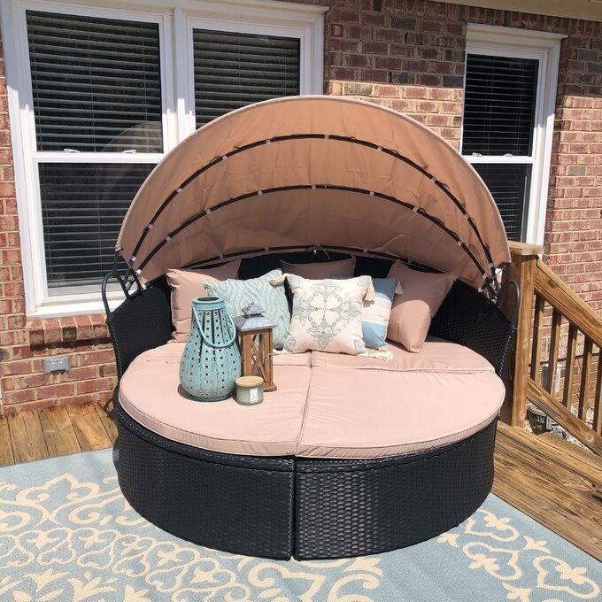 The wicker outdoor daybed placed on a reviewer’s deck