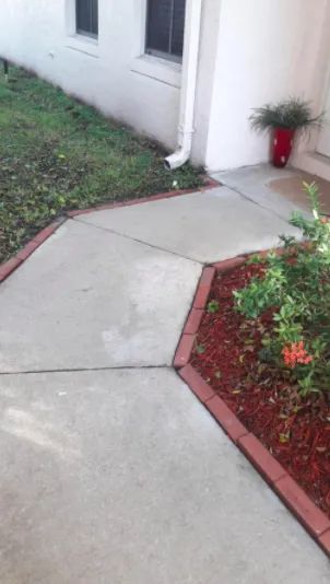 A transformed walkway, now clean and free of grass, after using the outdoor cleaner.