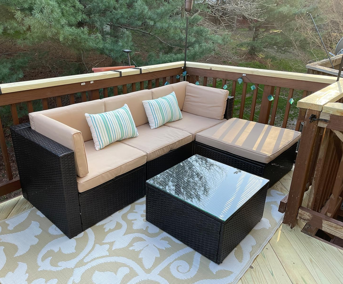 a reviewer's outdoor sectional sofa featuring a glass-top table