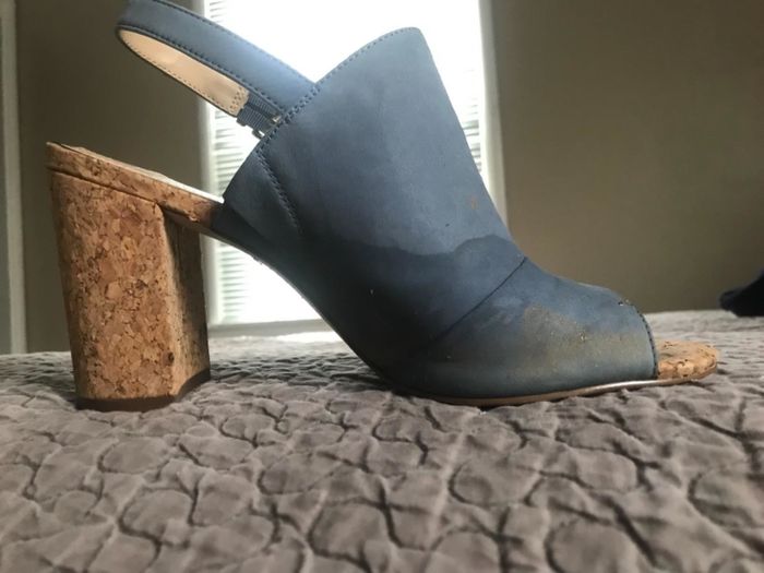 A reviewer photo of blue suede sandals with a water stain around the toe area