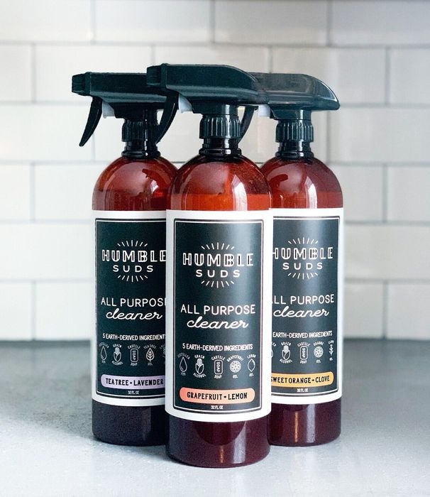 Three tall bottles of the all-purpose cleaning spray