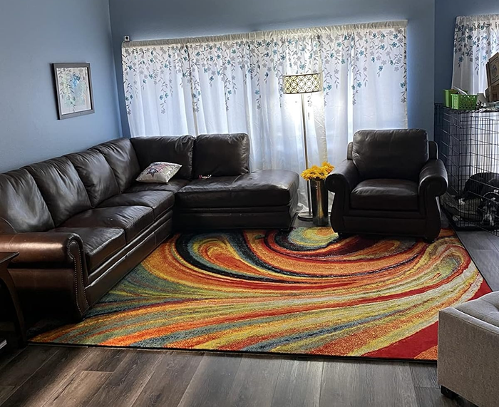 A reviewer’s image showcasing the abstract rug beautifully placed in a stylish living room.