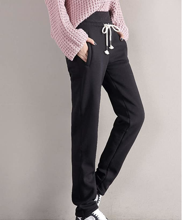 Model wearing black drawstring joggers.
