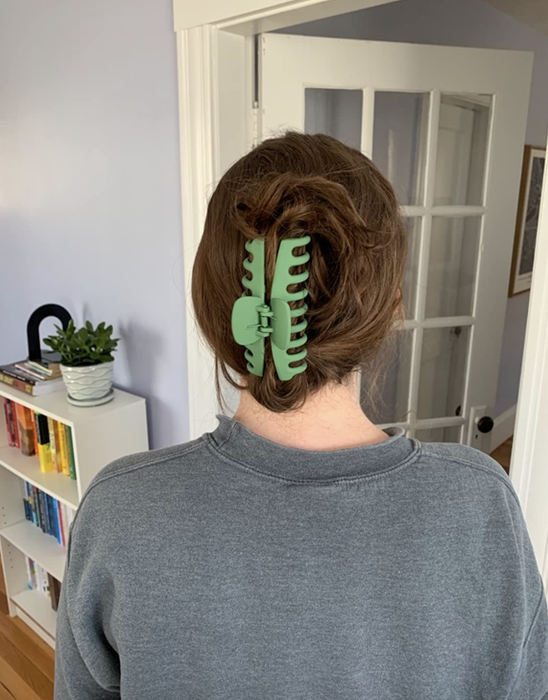 Reviewer sporting their hair up, held in place with a green claw clip.