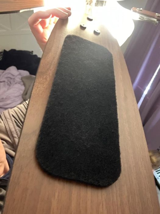 A black carbon filter attached to a ceiling fan blade