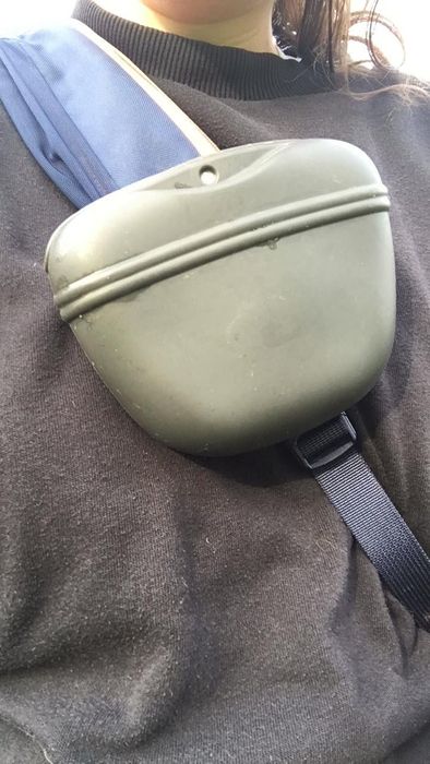 A reviewer showing off the pouch clipped to their crossbody bag