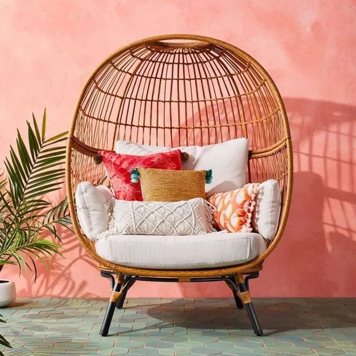 A white chair adorned with accent cushions for added comfort and style.