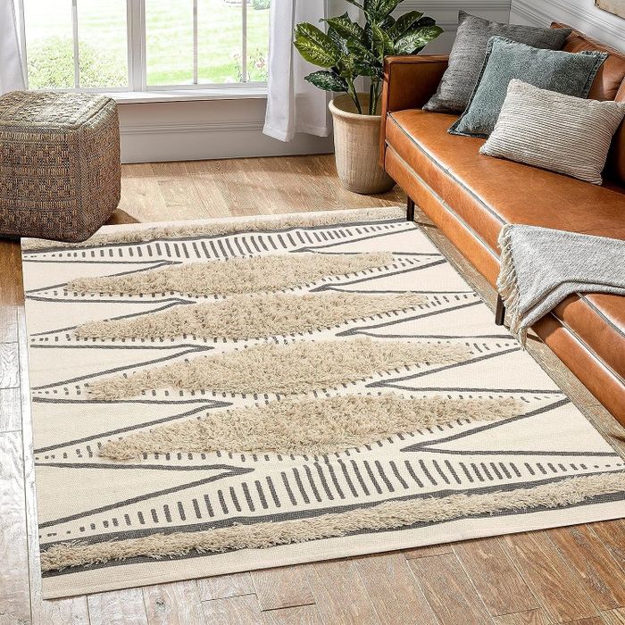 The geometric rug placed in a cozy living room.