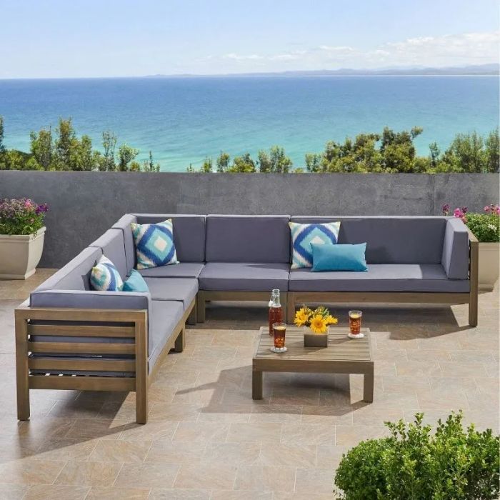 The sectional set in dark gray arranged on a terrace.