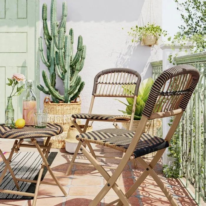 Two matching chairs and a table placed on a deck, creating a cozy outdoor seating area.