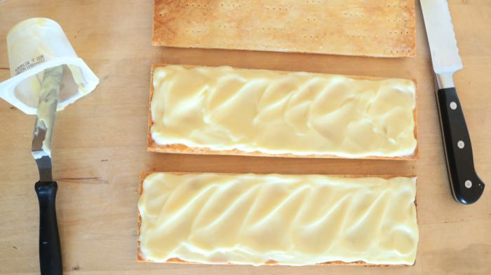 Vanilla pudding evenly spread across two of the three pastry layers.