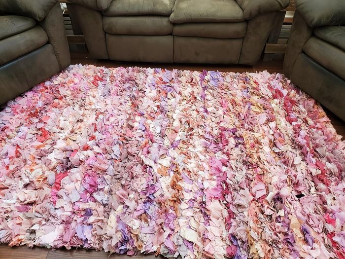 A reviewer’s image showcasing the ivory and pink shag rug in a cozy setting.