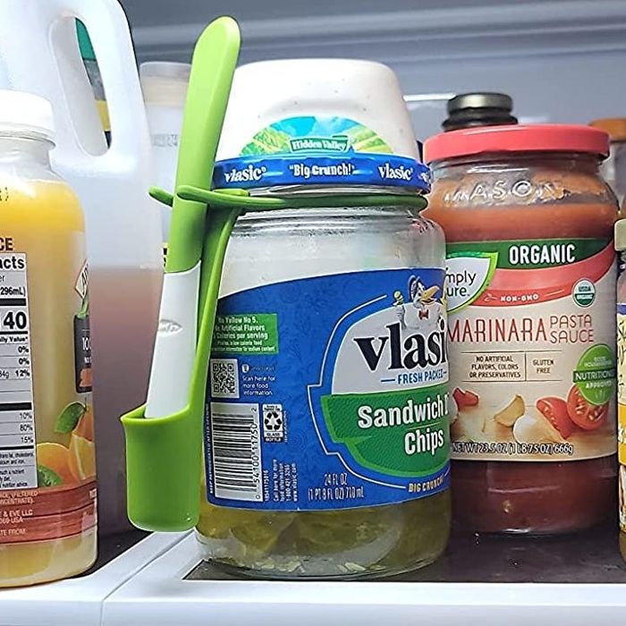 A reviewer shows the snack fork stuck in a jar of pickles in their fridge