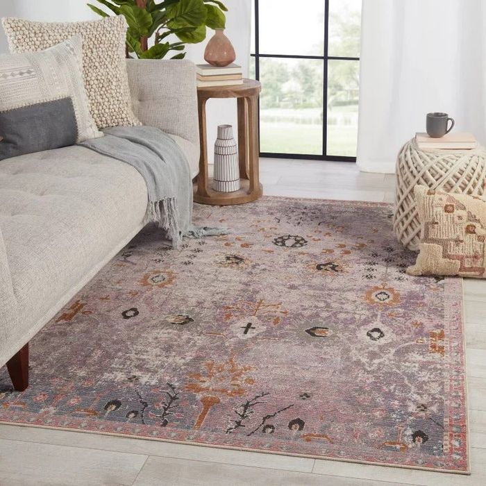 The Elva indoor/outdoor purple and gold rug displayed in a stylish setting.
