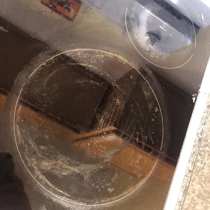 A reviewer's electric stovetop, completely covered in food and grime before cleaning.