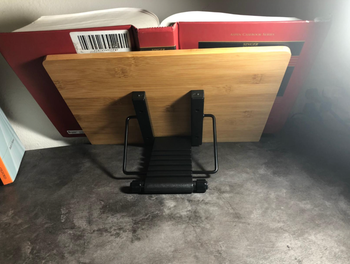 A reviewer image showing the back of the stand holding a textbook upright.