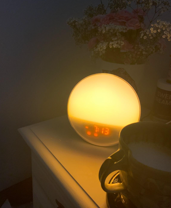 The clock glowing with a soft, warm yellow light