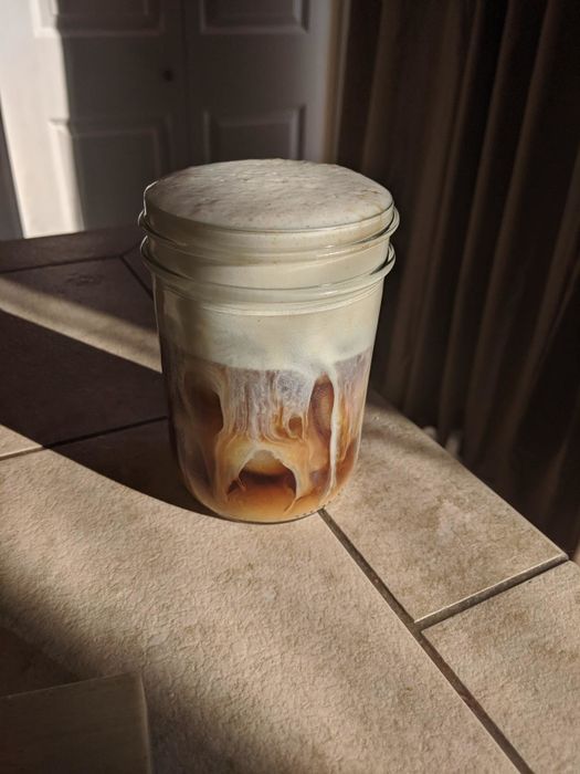 Iced coffee topped with a layer of frothed milk