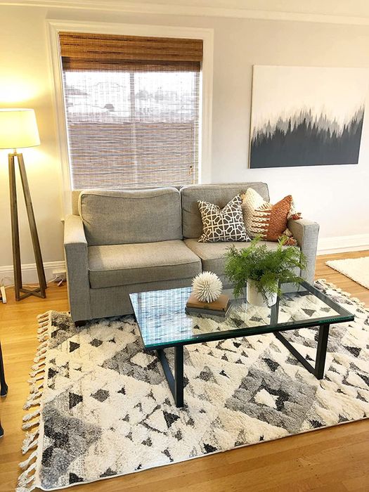Photo of the ivory and grey rug positioned in a contemporary living area