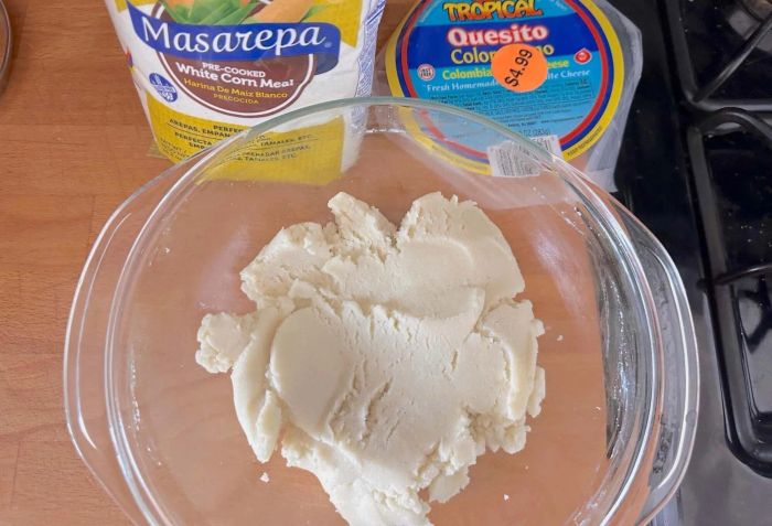 Arepa dough resting in a bowl before shaping.