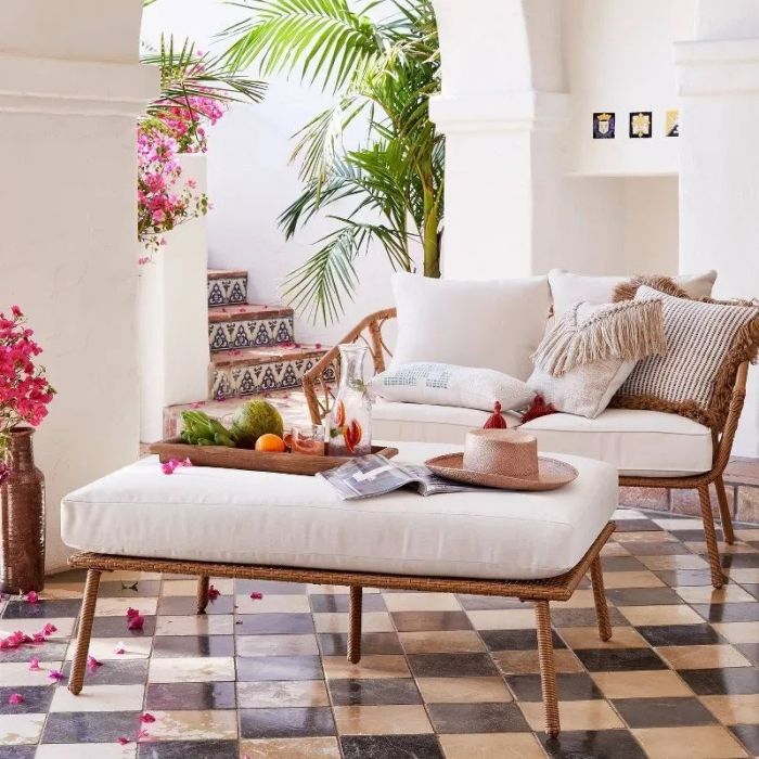 The ottoman positioned in front of the matching loveseat.