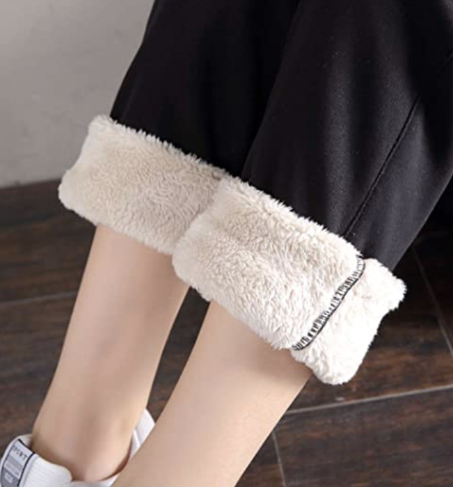 Model with joggers rolled up to reveal the soft white lining inside.