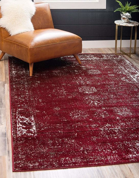The dark red rug.