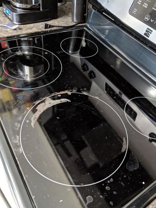 before: glass cooktop covered in cooked-on stains