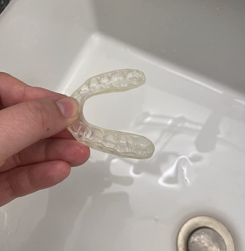 The same reviewer's retainer now looking fresh and free of the yellow stains that were on it before, after using the cleaner